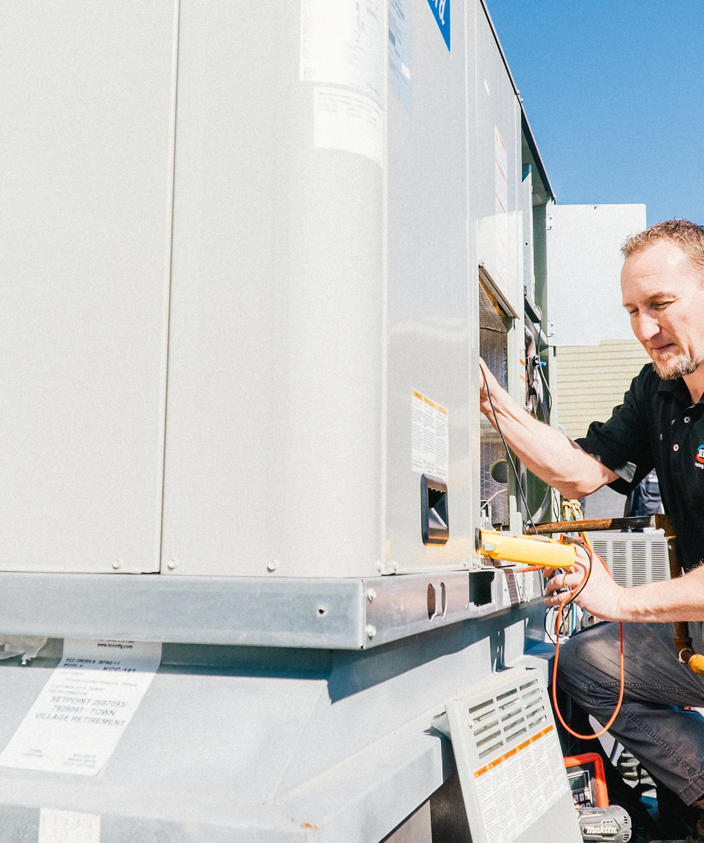 Owner Nathan Ellison working on an HVAC unit