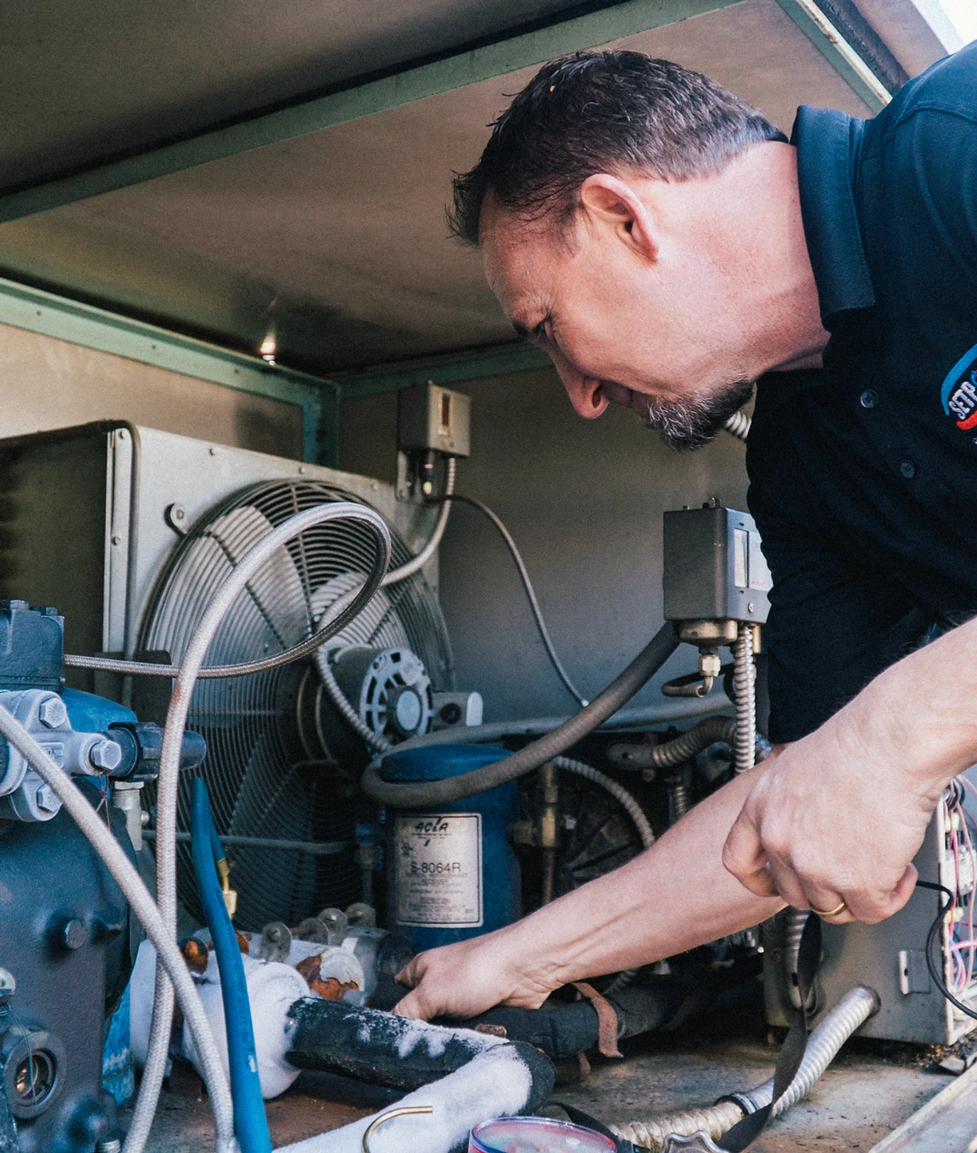 Owner of Setpoint Heating and Cooling working on an HVAC system